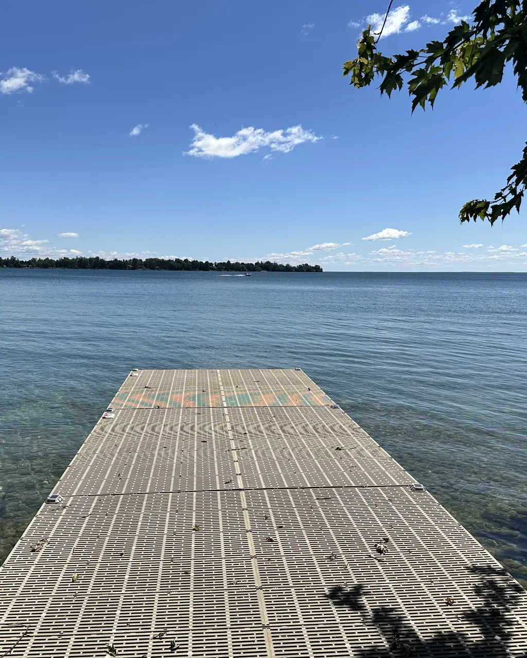 Dock extending into the clear waters of Lake Simcoe at Bonnie Beach, Ramara, Ontario